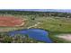 Scenic pond surrounded by green fields and walking trails, providing a tranquil environment and recreational opportunities at 3755 Shefield Dr, Broomfield, CO 80020
