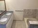 Bathroom with double sinks, granite countertop, and bathtub at 20971 E 42Nd Ave, Denver, CO 80249