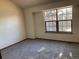 Simple bedroom with large window and neutral carpet at 20971 E 42Nd Ave, Denver, CO 80249