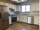 Kitchen with stainless steel appliances and white cabinets at 20971 E 42Nd Ave, Denver, CO 80249