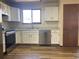 Bright kitchen with stainless steel appliances and light wood laminate flooring at 20971 E 42Nd Ave, Denver, CO 80249