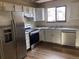 Kitchen with stainless steel appliances and white cabinets at 20971 E 42Nd Ave, Denver, CO 80249