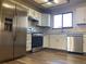 Kitchen with stainless steel appliances and white cabinets at 20971 E 42Nd Ave, Denver, CO 80249