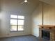 Living room with vaulted ceiling, fireplace and large window at 20971 E 42Nd Ave, Denver, CO 80249