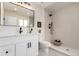 Modern bathroom with white vanity, updated fixtures, and a sleek glass-enclosed shower for a spa-like feel at 855 Newark St, Aurora, CO 80010