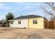 Home exterior showcasing rock landscaping, a private driveway, and a fenced yard at 855 Newark St, Aurora, CO 80010