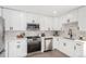 A modern kitchen featuring white cabinets, stainless steel appliances, and stone backsplash at 855 Newark St, Aurora, CO 80010