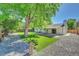 Large backyard with mature tree and gravel pathway at 6749 Ingalls St, Arvada, CO 80003