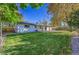 Landscaped backyard, featuring a grassy area and patio at 6749 Ingalls St, Arvada, CO 80003