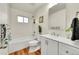 Updated bathroom with white subway tile, new vanity, and wood-look floors at 6749 Ingalls St, Arvada, CO 80003