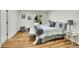 Bright bedroom featuring light gray bedding and wood-look floors at 6749 Ingalls St, Arvada, CO 80003