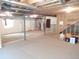 Unfinished basement space featuring new carpet, exposed ceiling, and mechanical systems at 7354 Benton St, Arvada, CO 80003