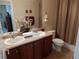 Bright bathroom featuring dual sinks, tiled flooring, and a toilet at 7354 Benton St, Arvada, CO 80003