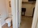 Small water closet visible with commode and view into walk-in closet area at 7354 Benton St, Arvada, CO 80003