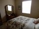 Bedroom with large window, carpet, and floral bedding at 7354 Benton St, Arvada, CO 80003