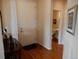 Inviting foyer leading to a half bath featuring hardwood floors at 7354 Benton St, Arvada, CO 80003