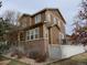 Two-story home featuring a side yard and upper level balcony at 7354 Benton St, Arvada, CO 80003