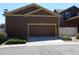 Detached two-car garage with ample parking space, complimented by subtle landscaping and exterior lighting at 7354 Benton St, Arvada, CO 80003
