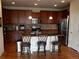 Kitchen featuring dark wood cabinetry, stainless steel appliances and spacious center island at 7354 Benton St, Arvada, CO 80003