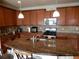 Kitchen featuring dark wood cabinetry, stainless steel appliances and spacious center island at 7354 Benton St, Arvada, CO 80003