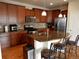 Kitchen featuring dark wood cabinetry, stainless steel appliances and spacious center island at 7354 Benton St, Arvada, CO 80003