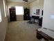 Spacious living area with natural light, featuring shelving units and desk at 7354 Benton St, Arvada, CO 80003