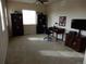 Spacious living room area with neutral carpet and built-in shelving for decorative storage at 7354 Benton St, Arvada, CO 80003