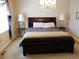 Elegantly designed main bedroom featuring a large bed, side tables, lamps, and a decorative chandelier at 7354 Benton St, Arvada, CO 80003