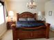 Bedroom featuring a decorative bed frame, chandelier, and matching nightstands at 7354 Benton St, Arvada, CO 80003