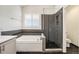 Bright bathroom with a glass-enclosed shower, a soaking tub and a window allowing natural light at 16500 Timber Cove St, Hudson, CO 80642
