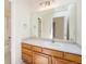 Bathroom features a large mirror, vanity, and tub with shower combo, designed for functionality and ease at 16500 Timber Cove St, Hudson, CO 80642