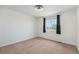 A bright room features a window and neutral walls is perfect for relaxation at 16500 Timber Cove St, Hudson, CO 80642