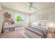Bedroom with a bed, open shelves, and large windows, creating a bright and functional space at 16500 Timber Cove St, Hudson, CO 80642