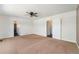 Spacious bedroom featuring neutral carpet, ceiling fan, and multiple entryways for an open and airy feel at 16500 Timber Cove St, Hudson, CO 80642