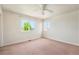 A bright room that includes a window and carpeted floors offers comfort and functionality at 16500 Timber Cove St, Hudson, CO 80642