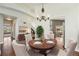 Inviting dining room with hardwood floors, a chandelier, and a view of the staircase and open-concept layout at 16500 Timber Cove St, Hudson, CO 80642