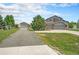 Two-story home featuring a three-car garage and detached garage, complemented by a well-maintained lawn at 16500 Timber Cove St, Hudson, CO 80642