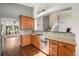 Charming kitchen featuring wood cabinets, granite countertops, stainless steel appliances, and hardwood floors at 16500 Timber Cove St, Hudson, CO 80642
