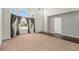 Bright, open living room features hardwood flooring, large windows and plush carpeting, perfect for gatherings at 16500 Timber Cove St, Hudson, CO 80642