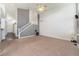 Open living room area featuring high ceilings, carpet floors, and a view of the entryway at 16500 Timber Cove St, Hudson, CO 80642