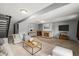 Spacious finished basement with a fireplace and ample seating, creating a cozy and inviting atmosphere at 6838 S Broadway, Centennial, CO 80122