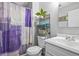 Clean bathroom featuring a colorful shower curtain, toilet, vanity, and an overhead plant, creating a refreshing space at 6838 S Broadway, Centennial, CO 80122