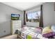 Cozy bedroom with a bright window and quilted bedding, offering comfort at 6838 S Broadway, Centennial, CO 80122