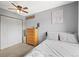 Comfortable bedroom with neutral tones, a ceiling fan, closet, dresser, and a bed, perfect for a relaxing retreat at 6838 S Broadway, Centennial, CO 80122