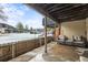 Private covered patio with wood fence, providing a serene space for relaxation and outdoor enjoyment at 6838 S Broadway, Centennial, CO 80122