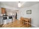 Sunny dining area boasts hardwood floors, counter seating, and a view into the kitchen at 3629 Kalamath St, Denver, CO 80211