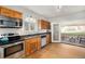 Bright kitchen features stainless steel appliances, wood cabinets and opens to a patio at 3629 Kalamath St, Denver, CO 80211