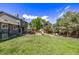 Large backyard with a deck, grill, shed, big trees, seating, and lawn at 6062 S Newport St, Centennial, CO 80111
