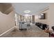 Finished basement with a gray sectional, mounted TV, and space for playing at 6062 S Newport St, Centennial, CO 80111