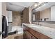 Full bathroom with updated shower, granite counter tops, and decorative mirror at 6062 S Newport St, Centennial, CO 80111